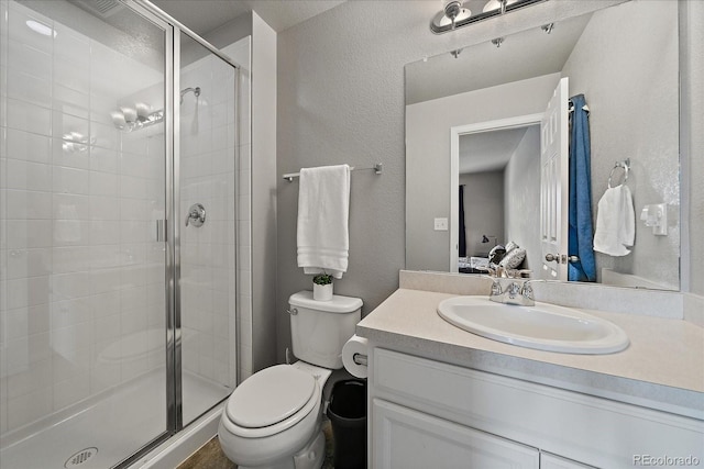 8695 Torrey St, Arvada, CO 80007 - full bathroom with toilet, a stall shower, a textured wall, vanity, and connected bathroom
