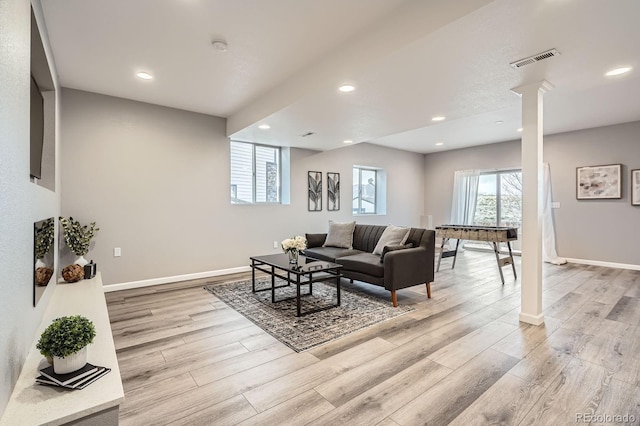 8695 Torrey St, Arvada, CO 80007 - living room with ornate columns, light wood finished floors, baseboards, and recessed lighting