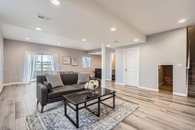 8695 Torrey St, Arvada, CO 80007 - living area featuring light wood-style floors, stairway, baseboards, and recessed lighting