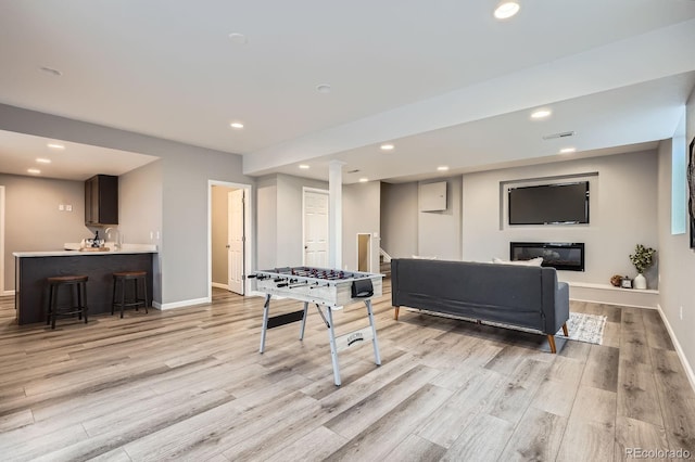 8695 Torrey St, Arvada, CO 80007 - game room featuring light wood finished floors, baseboards, recessed lighting, and a sink