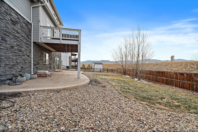 8695 Torrey St, Arvada, CO 80007 - fenced backyard with a patio, a mountain view, an outdoor structure, and a balcony
