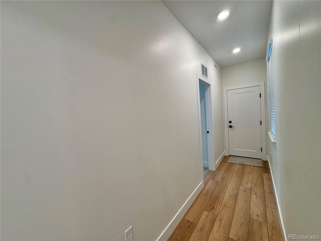 corridor with recessed lighting, baseboards, visible vents, and light wood finished floors