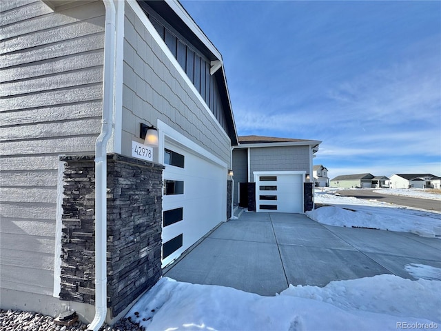 view of side of property featuring a garage, board and batten siding, and an outdoor structure