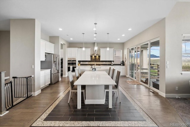 19409 W 88th Dr, Arvada, CO 80007 - dining area with dark wood-type flooring, recessed lighting, and baseboards