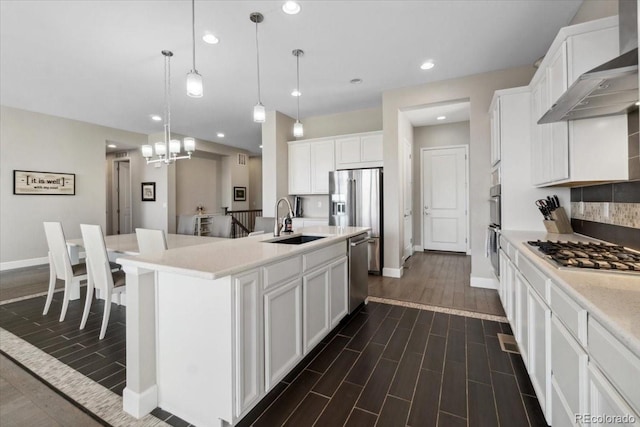 19409 W 88th Dr, Arvada, CO 80007 - kitchen featuring a sink, appliances with stainless steel finishes, wall chimney range hood, baseboards, and recessed lighting