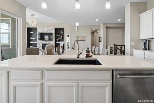19409 W 88th Dr, Arvada, CO 80007 - kitchen featuring stainless steel dishwasher, a sink, white cabinetry, hanging light fixtures, and recessed lighting