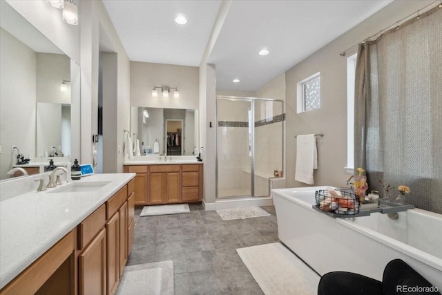 19409 W 88th Dr, Arvada, CO 80007 - bathroom featuring a shower stall, a tub to relax in, two vanities, and recessed lighting