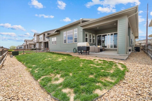 19409 W 88th Dr, Arvada, CO 80007 - back of house featuring a patio, central AC, and outdoor lounge area