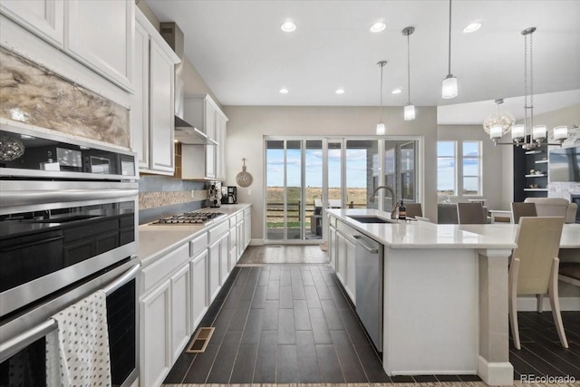 19409 W 88th Dr, Arvada, CO 80007 - kitchen with stainless steel appliances, a sink, healthy amount of natural light, a chandelier, and recessed lighting