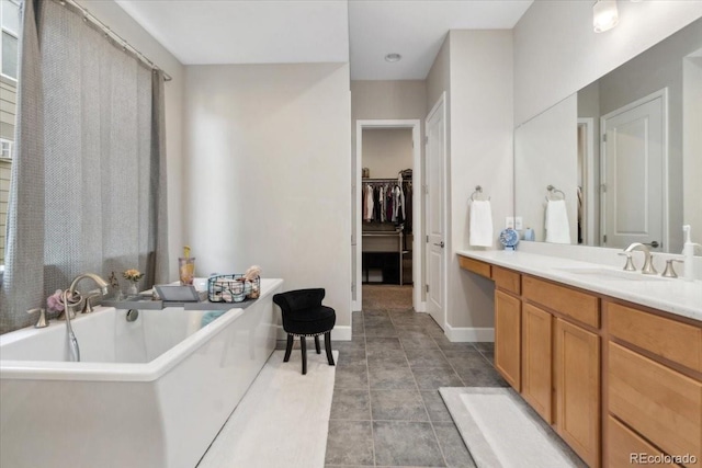 19409 W 88th Dr, Arvada, CO 80007 - full bath featuring vanity, a walk in closet, a soaking tub, baseboards, and tile patterned flooring