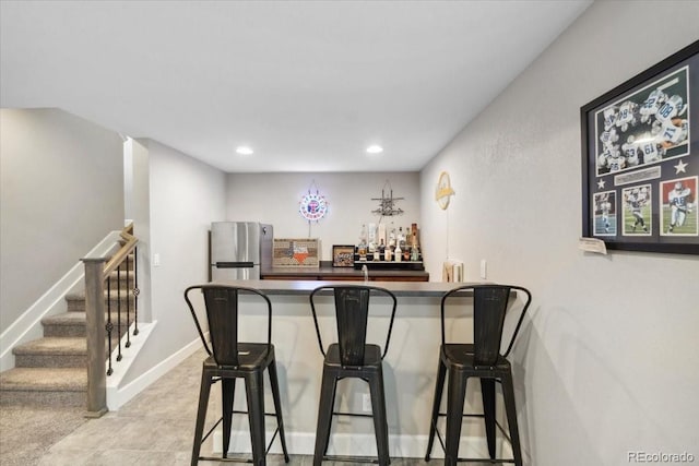 19409 W 88th Dr, Arvada, CO 80007 - indoor wet bar featuring freestanding refrigerator, stairs, and recessed lighting