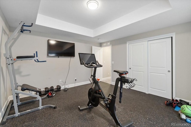 19409 W 88th Dr, Arvada, CO 80007 - exercise room with a tray ceiling and baseboards
