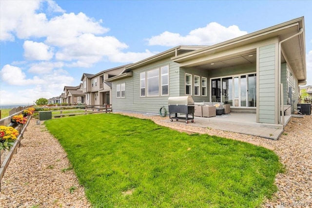 19409 W 88th Dr, Arvada, CO 80007 - back of house with a patio, a yard, central AC, and outdoor lounge area