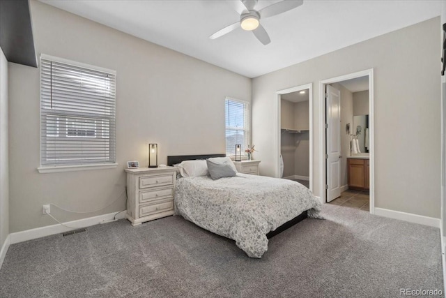 19409 W 88th Dr, Arvada, CO 80007 - bedroom featuring baseboards, light colored carpet, a spacious closet, connected bathroom, and a ceiling fan
