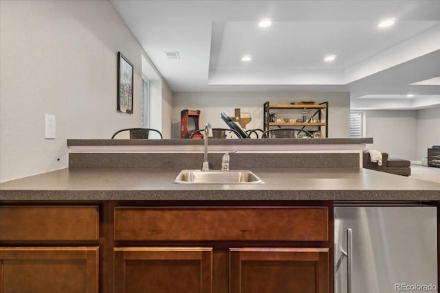19409 W 88th Dr, Arvada, CO 80007 - kitchen with refrigerator, a sink, dark countertops, open floor plan, and recessed lighting