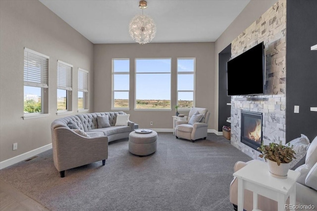 19409 W 88th Dr, Arvada, CO 80007 - living area with a stone fireplace, carpet, and a chandelier