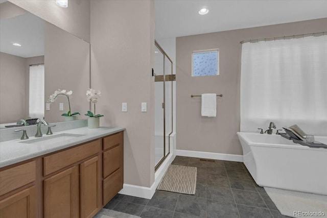 19409 W 88th Dr, Arvada, CO 80007 - full bathroom featuring a shower stall, vanity, a freestanding tub, and recessed lighting