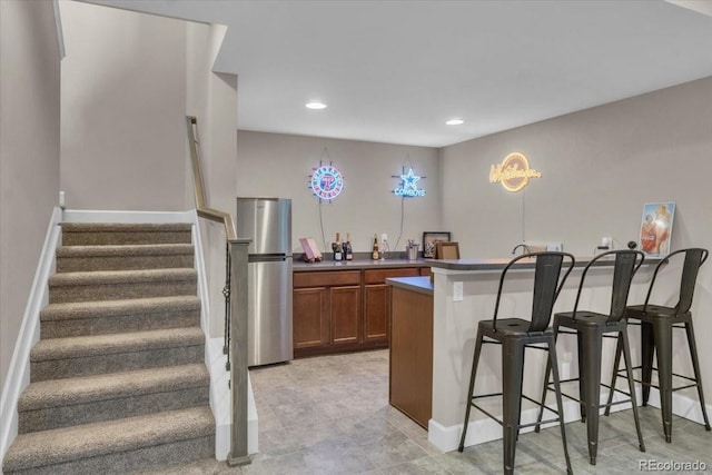 19409 W 88th Dr, Arvada, CO 80007 - bar featuring freestanding refrigerator, stairway, and recessed lighting