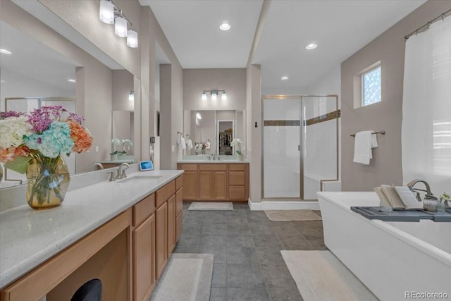 19409 W 88th Dr, Arvada, CO 80007 - full bath featuring a stall shower, two vanities, a soaking tub, tile patterned floors, and recessed lighting