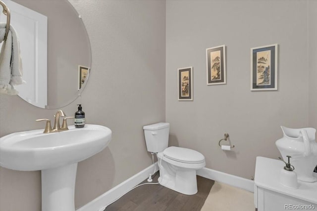 19409 W 88th Dr, Arvada, CO 80007 - half bathroom featuring toilet and wood finished floors