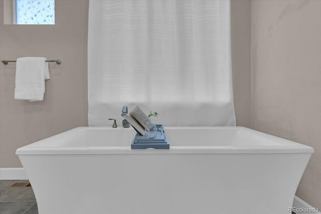 19409 W 88th Dr, Arvada, CO 80007 - bathroom with a freestanding bath and baseboards