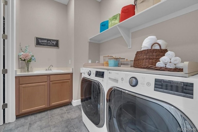 19409 W 88th Dr, Arvada, CO 80007 - washroom featuring washing machine and clothes dryer, light tile patterned floors, and cabinet space