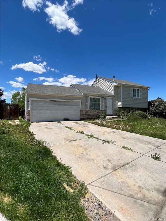 view of front of property with a garage and a front lawn