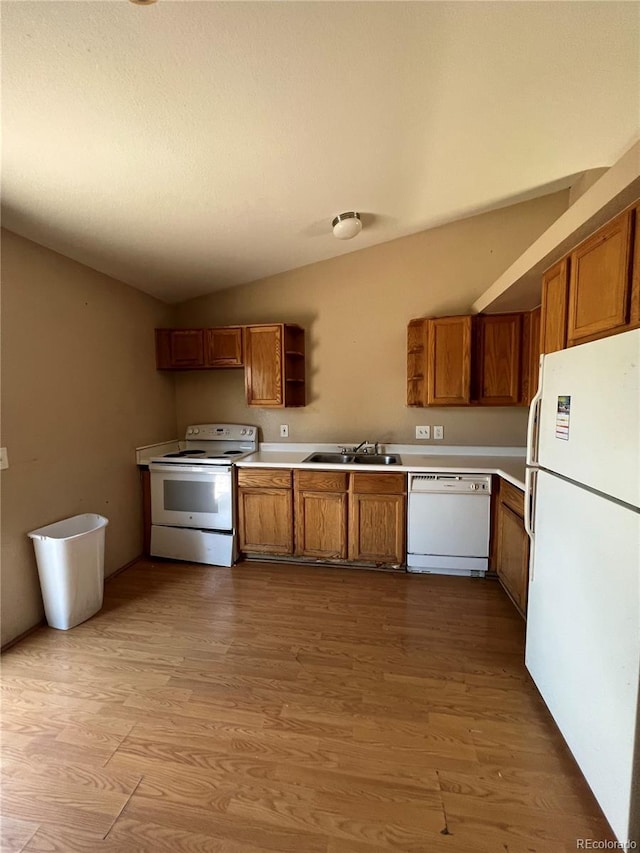 kitchen featuring sink, white appliances, and light hardwood / wood-style flooring