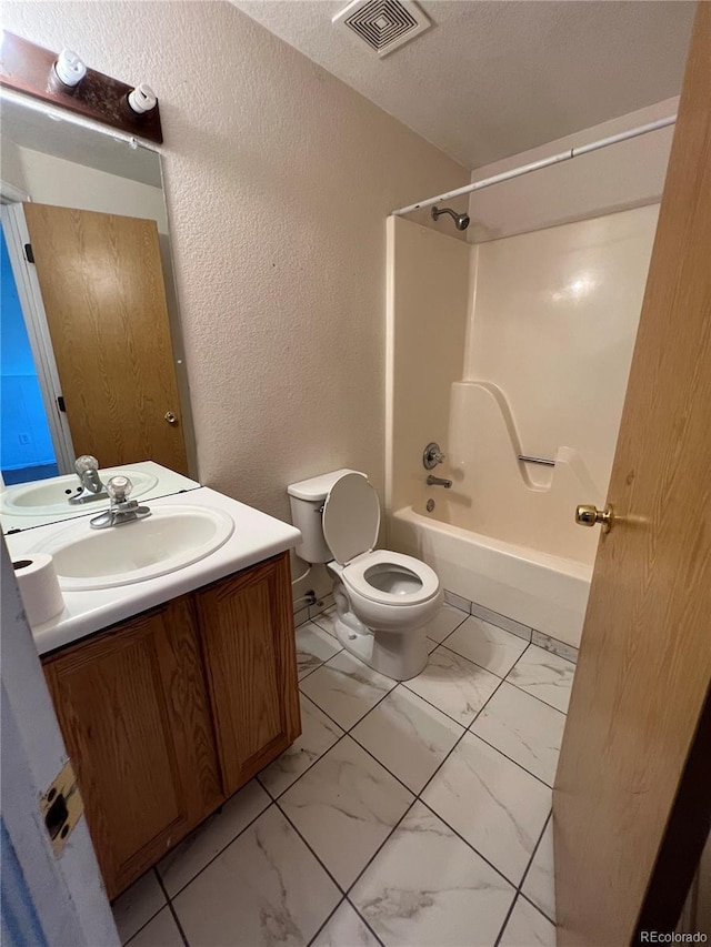 full bathroom featuring shower / tub combination, vanity, toilet, and a textured ceiling