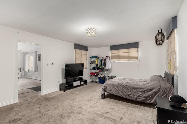 carpeted bedroom with baseboards