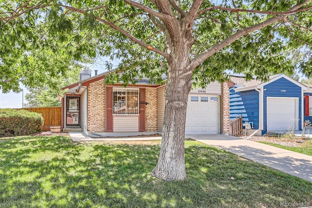 view of front of home with a front lawn and a garage