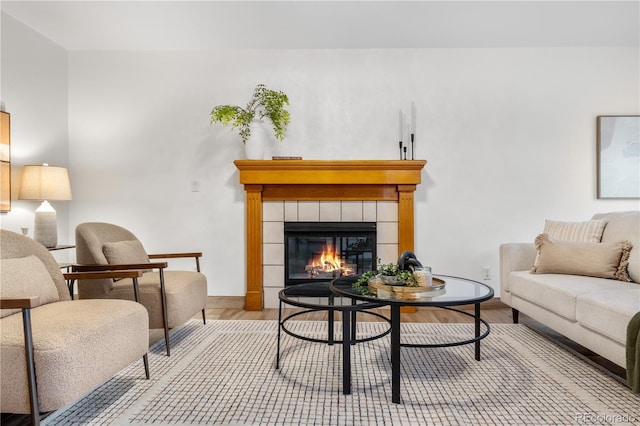 living room with wood finished floors and a fireplace