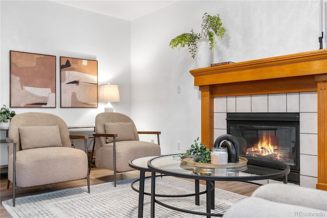 sitting room featuring wood finished floors and a tiled fireplace