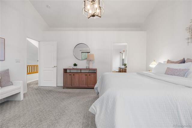 carpeted bedroom featuring baseboards and vaulted ceiling