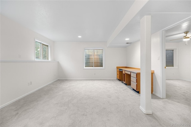 below grade area with light colored carpet, baseboards, recessed lighting, and ceiling fan