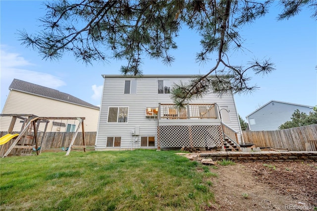 back of property with a playground, a wooden deck, and stairs