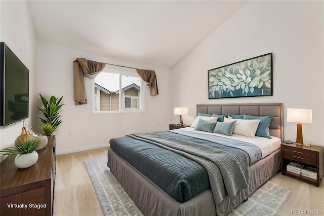 bedroom with light hardwood / wood-style floors and vaulted ceiling