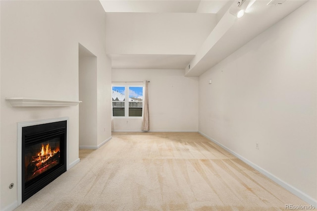 unfurnished living room featuring light carpet