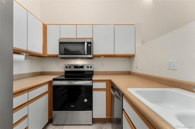 kitchen with white cabinetry, sink, and appliances with stainless steel finishes