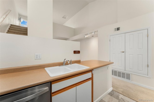 bathroom featuring vaulted ceiling and sink