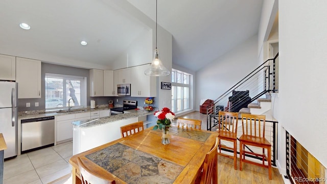 kitchen with appliances with stainless steel finishes, white cabinets, and a sink