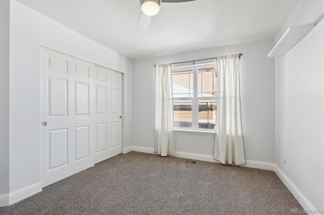 unfurnished bedroom with carpet flooring, ceiling fan, and a closet