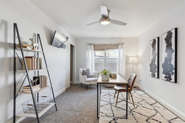 carpeted office featuring ceiling fan