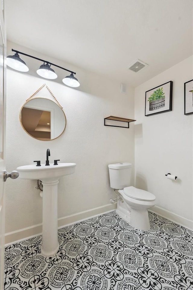 bathroom with tile patterned flooring and toilet