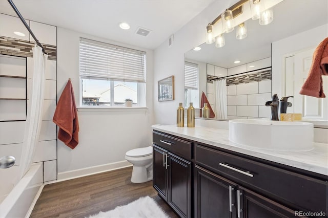 full bathroom featuring shower / bathtub combination with curtain, toilet, vanity, and hardwood / wood-style flooring