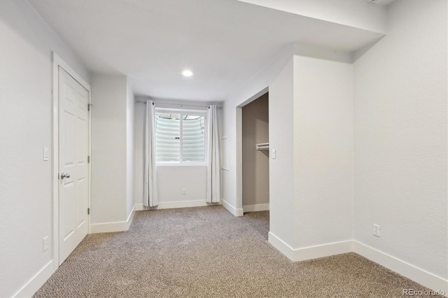 unfurnished bedroom featuring light carpet