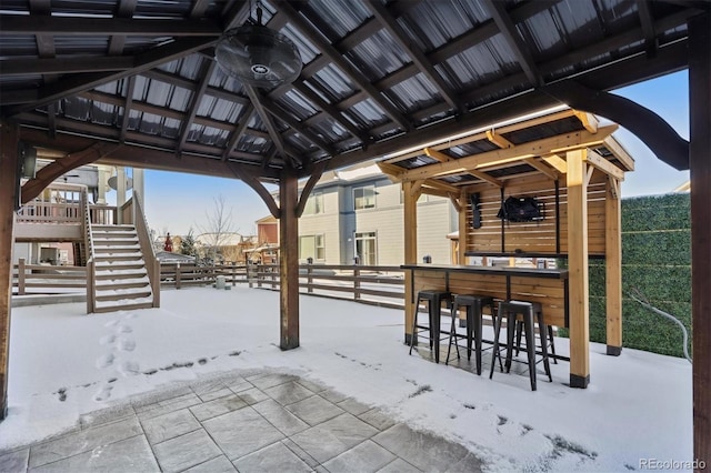 snow covered patio featuring a gazebo and an outdoor bar