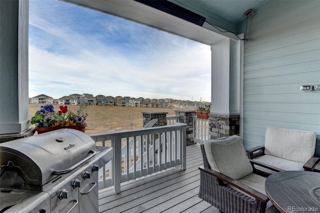 wooden deck featuring area for grilling and a residential view