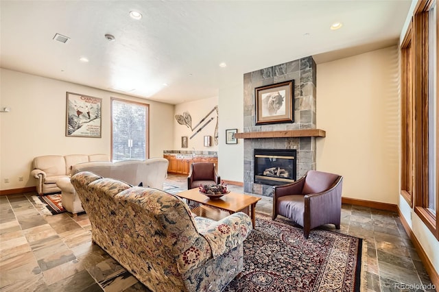 22787 US Highway 6 Unit 313, Dillon, CO 80435 - living area featuring stone tile floors, baseboards, a tiled fireplace, and recessed lighting