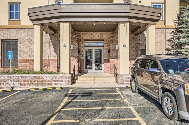 22787 US Highway 6 Unit 313, Dillon, CO 80435 - doorway to property with french doors, uncovered parking, and stone siding